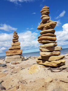 A stack of balancing stones, representing the mental effort of weighing every possibility during autistic overthinking.