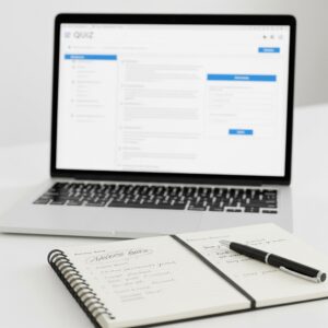 A laptop and notepad, symbolising the start of self-discovery through online autism screening tests.