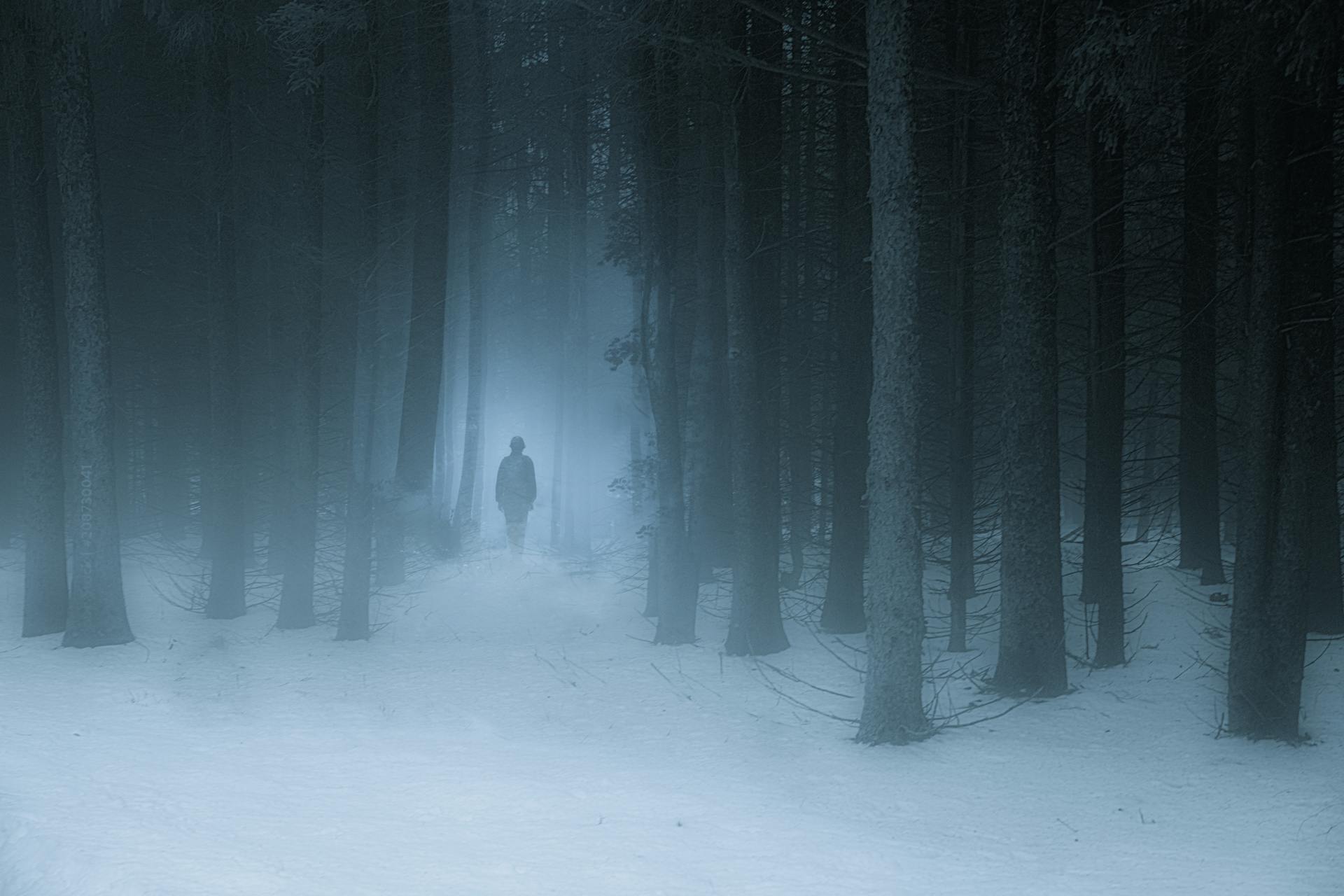 A person walking into a thick fog, symbolising the experience of autistic overwhelm and depression.