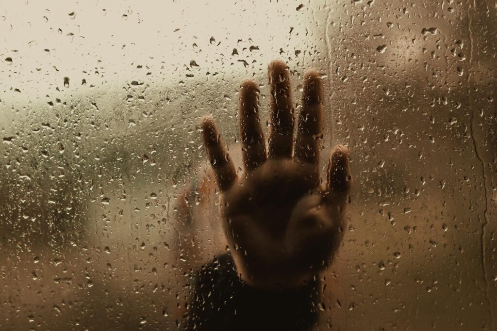 A rainy window symbolising how autistic burnout can reduce clarity.