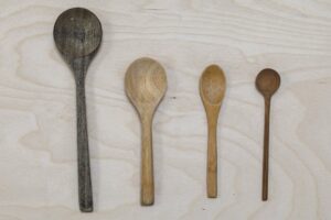 Spoons on a table, illustrating Spoon Theory and energy depletion in autistic burnout.