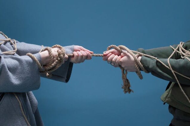 An image depicting a tug of war. An abstract representation of the inner conflict of ASD and ADHD.