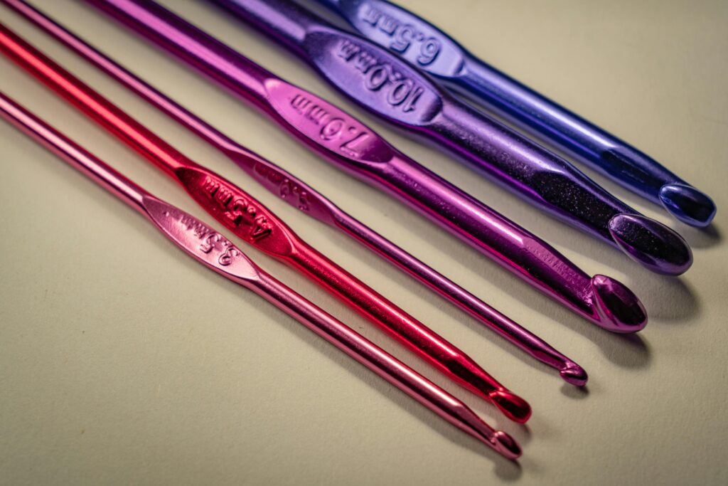 A selection of coloured metallic crochet hooks of varying sizes